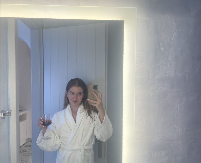 Mirror selfie of a glass of wine
