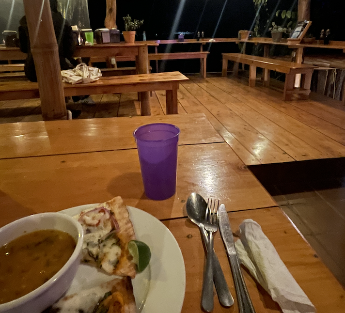 soup and pizza at a picnic table