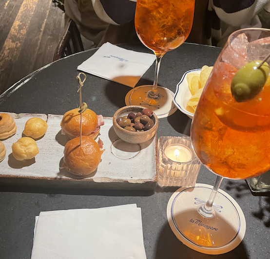 aperol sprtiz with different appetizer bites